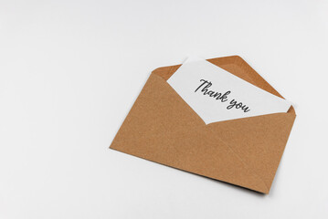 Thank you message in brown envelope on white background