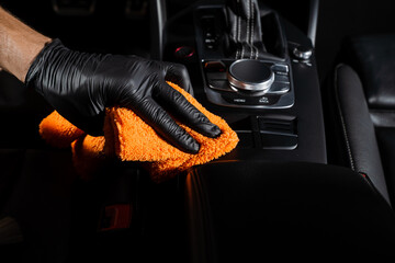 Hand car interior drying of gearbox and dashboard using microfiber in detailing auto service....