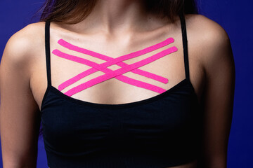 Cosmetology kinesio tapes on young woman chest. Body care modern treatment for tighten skin muscle tissue and improve blood circulation. Sport. Beautiful body. Fit. Care.