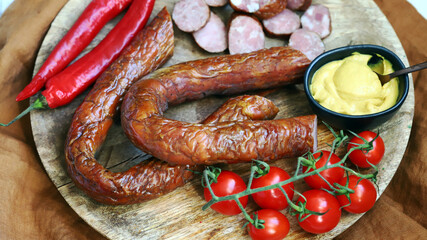 Fresh homemade sausages on a wooden tray.