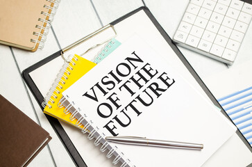 Vision Of The Future words on white notebook with colourful notepads and calculator
