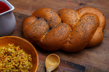 Wicker challah on the table and a fragment of a cup with boiled spelled.