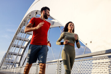 Couple young man and woman in sportswear exercise and run outside