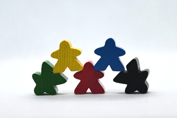 Colorful board game meeples on a white background. Concept for games night, Euro games and team work.