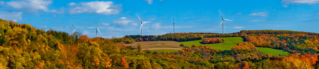 Windmill Turbines line the mountaintop ridge in central NY state.  Trying to offset CO2 emissions with wind farms.  Climate Change is forcing alternative power.  Autumn Leaves and Windmills.
