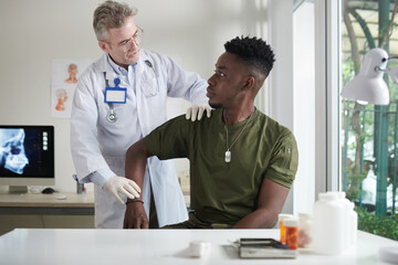 Doctor Palpating Dislocated Shoulder
