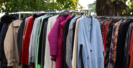 vintage used and new clothes for sale in the stall stand at the flea market