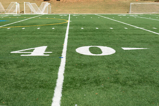 Green Synthetic Turf Field At The 40 Yard Line On A Clear Autumn Day With A Shallow Depth Of Field And Copy Space