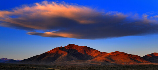 Sunset or Sunrise on Mountain with Cloud in Sky