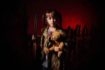 Obraz na płótnie Canvas Children of war. A girl in Ukrainian clothes, a military jacket, a gun in her hands and a teddy bear. Symbolic photo. Photo project by Golovchenko Dmytro