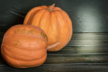 Two pumpkins on a black background. Halloween theme.