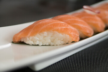 White plate with salmon and rice sushi
