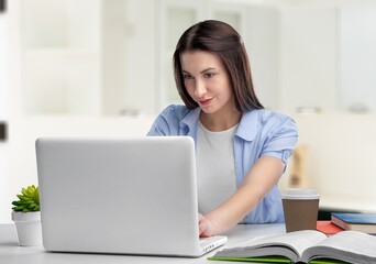 Fototapeta premium Smiling student woman study with books at home interior
