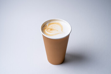 cappuccino in a disposable cardboard craft cup