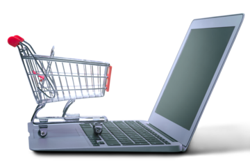 Laptop and shopping cart on white background