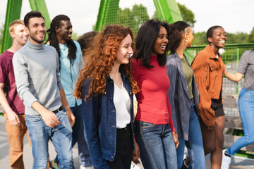 Obraz premium Group of multiracial people having fun outdoor laughing together .