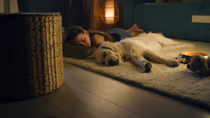 Girl lying on mild carpet with dog, sleeping together, feeling relaxed after saturated day,...