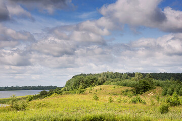 Sunny day and cloudy sky on the lake