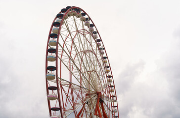 Attraction ferris wheel on the background of a stormy sky.