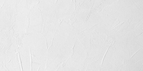Texture background of white concrete wall. Empty light cement wall. Light white panoramic background with space for text. Clean stucco rough wall. One color monochrome structure.
