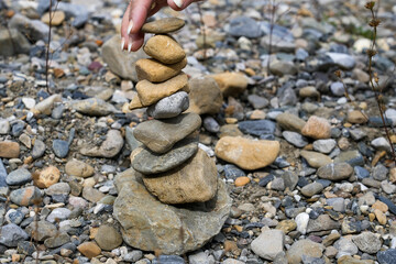Fototapeta na wymiar close-up of a hand-built mini tower of rover stones and pebbles 