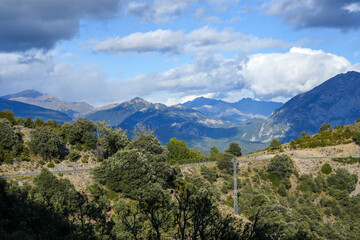 Fototapeta premium magnificent view of Pyrenees mountains with rock outcrops and forest covered slopes