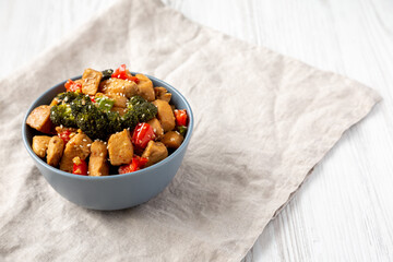 Homemade One-Pan Chicken And Broccoli Stir-Fry in a Bowl, side view. Copy space.