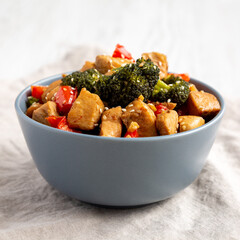Homemade One-Pan Chicken And Broccoli Stir-Fry in a Bowl, side view. Close-up.