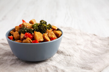 Homemade One-Pan Chicken And Broccoli Stir-Fry in a Bowl, side view. Copy space.