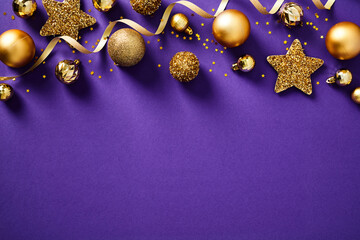 Purple Christmas background with gold decorations, balls and stars top view.
