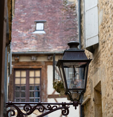 old black cast iron street lamps fitted with modern LED bulbs in a medieval town