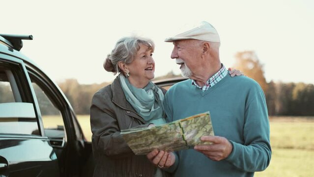 Senior couple&nbsp;looking at map on a road trip

