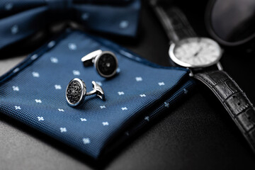 Business accessories. Luxury Men's cufflinks with watch, breastplate and sunglasses close up.