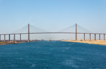 Convoy of vessels transiting through the Suez Canal, North bound, approaching and passing under Egyptian-Japanese Friendship bridge or Al Salam bridge.