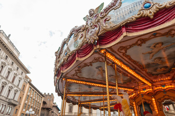 Beautiful vintage carousel with lights and decorations in the ancient European city of Florence, Italy