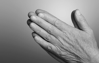 Image black and white hand praying to God at church.