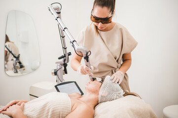 beauty professional applying treatment to a woman with relaxed face