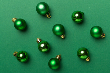 Christmas balls on color background, top view