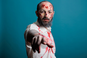 Portrait of halloween zombie posing on camera, looking spooky and dangerous with apocalyptic scars...