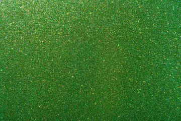 Background with sparkles. Backdrop with glitter. Shiny textured surface. Very dark lime green