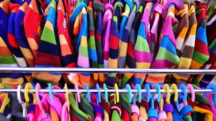 Made in Peru handicraft woolen, jackets, sweaters and vests made from alpaca with traditional design at market.