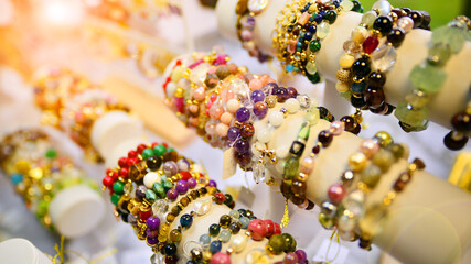 Esoteric and colorful background. Gemstone bracelets and necklaces. Healing, powerful crystal and stones  energy. 