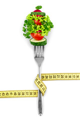 Fresh mixed vegetables on fork with measuring tape
