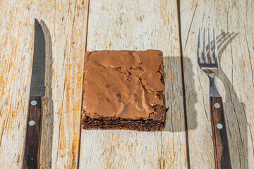 delicious homemade chocolate brownie over table with fork and knife. tasty chocolate dessert