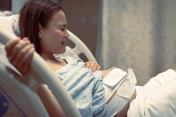 A pregnant woman in labor, suffering from painful contractions. Childbirth and maternity.