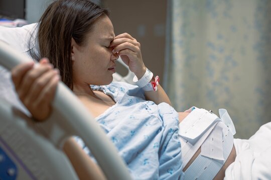 A depressed pregnant woman worried about her baby, in the hospital clinic.