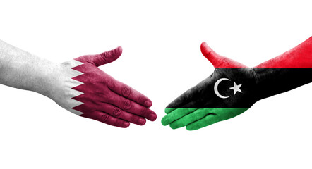 Handshake between Libya and Qatar flags painted on hands, isolated transparent image.