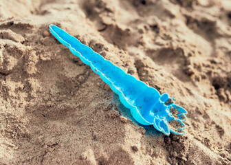 toys are lying in the sand on the beach