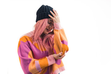 Teenage caucasian girl with pink hair wearing sweater and beanie doing facepalm hand on forehead...