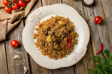 pilaf with beef on old wooden table top view